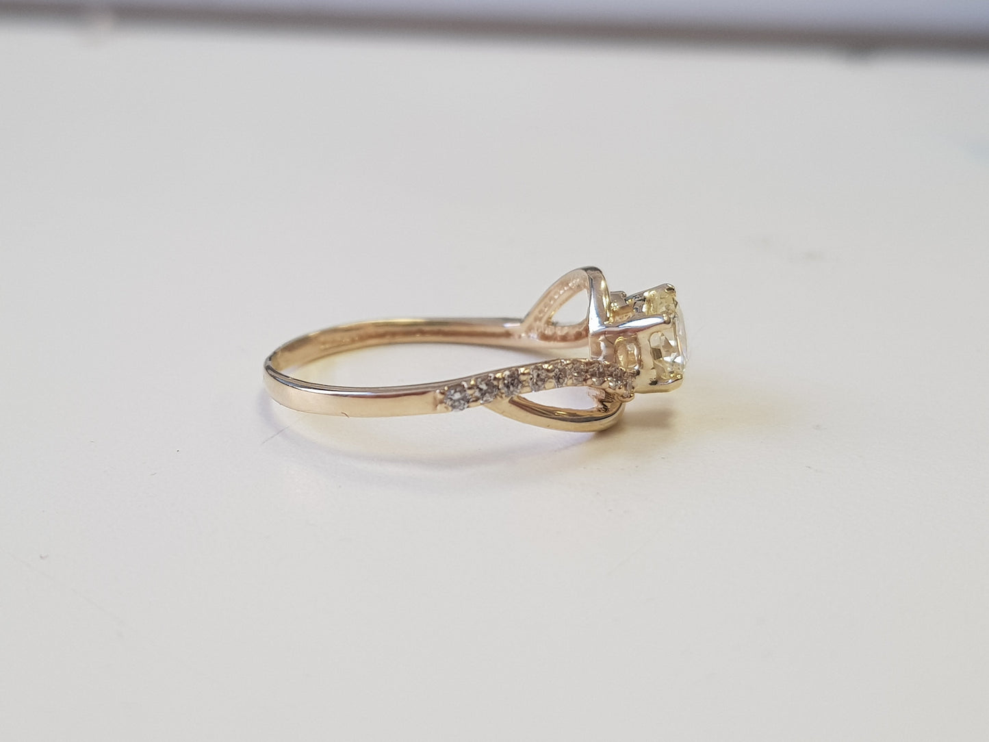 side picture of yellow gold twisted diamond engagement ring